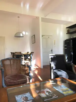 a living room with a table and two chairs at Beau 3 pièces 83 m2 au coeur du centre historique d'Aix en Provence in Aix-en-Provence
