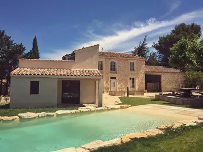 a house and a swimming pool in front of a house at Mas de L Angeos in Velleron