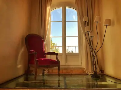 a room with a chair and a window at Mas de L Angeos in Velleron