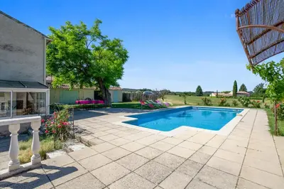 a swimming pool in a yard with a patio at Villa charmante à La Tour-d'Aigues avec piscine privée in La Tour-dʼAigues