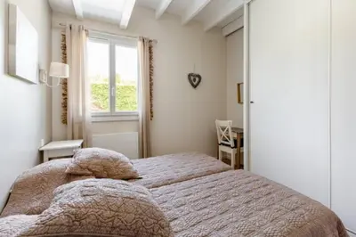 a bedroom with a bed and a window at La Bastide de l Etang in LʼIsle-sur-la-Sorgue