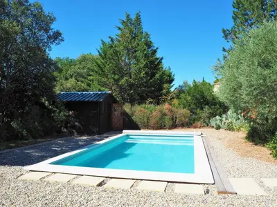 a swimming pool in a garden with a shed at Holiday Home near Mont Ventoux Ski Resort in Bédoin