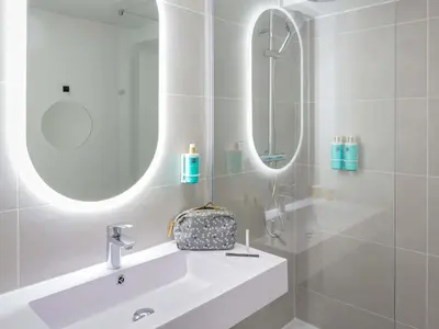a bathroom with a sink and a mirror at Novotel Aix-en-Provence Pont de L'Arc in Aix-en-Provence