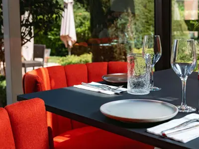 a restaurant with wooden tables and blue chairs at Novotel Aix-en-Provence Pont de L'Arc in Aix-en-Provence