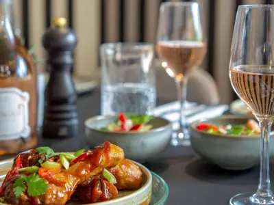 a table with a plate of food and glasses of wine at Novotel Aix-en-Provence Pont de L'Arc in Aix-en-Provence