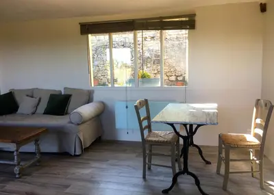 a living room with a couch and a table at l'Ecurie in Bonnieux