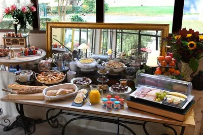 a buffet of food on a table in a room at The Originals Boutique, Hôtel du Parc, Cavaillon in Cavaillon