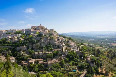 a village on a hill with houses at The Originals Boutique, Hôtel du Parc, Cavaillon in Cavaillon