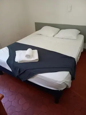 a pair of beds with towels on top of them at Hôtel Du Cours in Pertuis