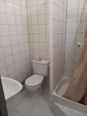 a bathroom with a toilet and a sink and a tub at Hôtel Du Cours in Pertuis