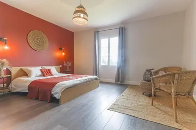 a bedroom with red walls and a bed and a window at Mas Carla in Noves