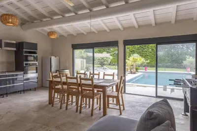 a kitchen and dining room with a table and chairs at Mas Carla in Noves
