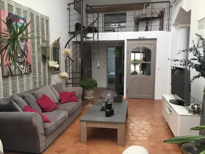 a living room with a couch and a table at Loft avec spa Lourmarin in Lourmarin