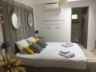 a bedroom with a bed with towels on it at Loft avec spa Lourmarin in Lourmarin