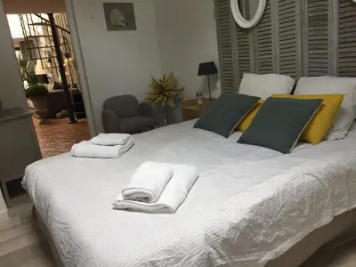 a bedroom with a large white bed with towels on it at Loft avec spa Lourmarin in Lourmarin