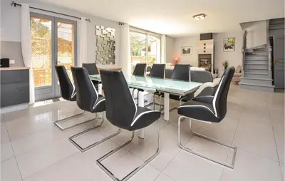 a dining room with a glass table and black chairs at Awesome Home In Saint-Rémy-De-Provence in Saint-Rémy-de-Provence