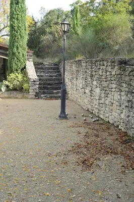 a street light in front of a stone wall at Mas de Michel in Bonnieux