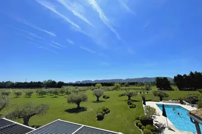 a large yard with a swimming pool and trees at Mas de Panière - Saint Remy de Provence in Paluds de Noves