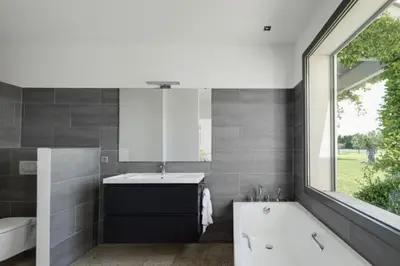 a bathroom with a tub and a sink and a mirror at Mas de Panière - Saint Remy de Provence in Paluds de Noves