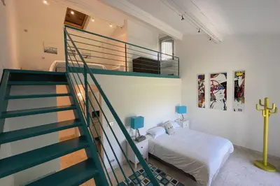a bedroom with a bunk bed and a staircase at Mas de Panière - Saint Remy de Provence in Paluds de Noves