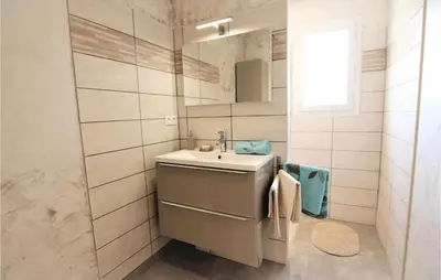 a bathroom with a sink and a mirror at Stunning Home In Monteux in Monteux