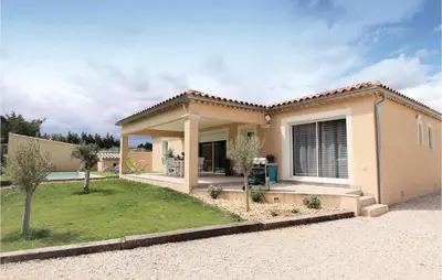 a villa with a garden and a house at Stunning Home In Monteux in Monteux