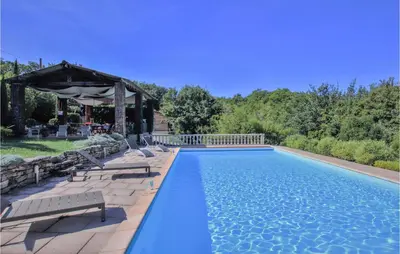 a swimming pool with chairs and a gazebo at Stunning Home In Saignon in Saignon