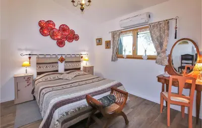 a bedroom with a bed and a mirror and a chair at Stunning Home In Saignon in Saignon