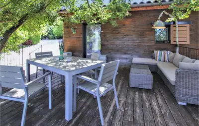 a patio with a table and chairs and a couch at Stunning Home In Saignon in Saignon