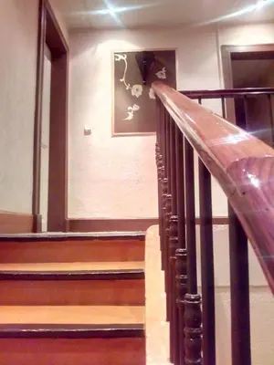 a staircase in a building with a picture on the wall at Auberge Du Parc in Orgon