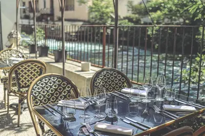 a table with wine glasses on top of it at Logis Hôtel Restaurant du Parc in Fontaine-de-Vaucluse