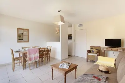 a living room with a couch and a table at Résidence Odalys Les Soleils du Luberon in Bonnieux