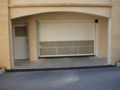 a garage with two garage doors in a building at Le Cigalou in Mallemort