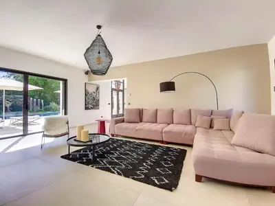 a living room with a couch and a table at Villa de prestige 10 personnes à Eyragues in Eyragues
