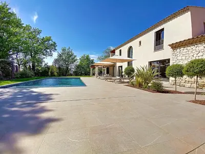 a house with a swimming pool next to a building at Villa de prestige 10 personnes à Eyragues in Eyragues