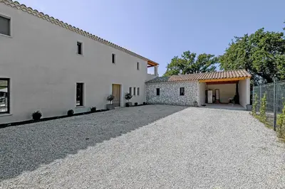 an empty driveway in front of a white building at Villa de prestige 10 personnes à Eyragues in Eyragues