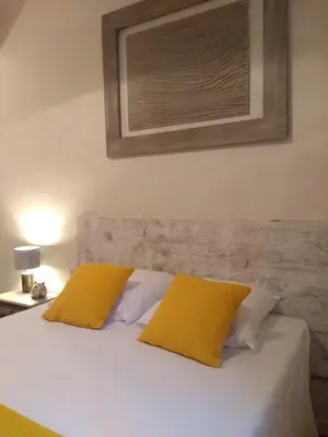 a bedroom with a bed with two yellow pillows at Mas de Camejean in Lambesc