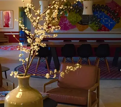 a table in a room with a painting on the wall at La Maison des Ocres - Provence in Roussillon