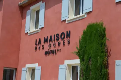 a red building with the words la maison les olivos at La Maison des Ocres - Provence in Roussillon