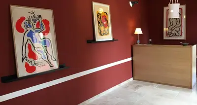 a hotel room with two beds and a yellow door at La Maison des Ocres - Provence in Roussillon