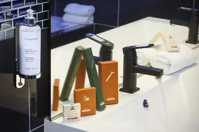 a counter with towels and a soap dispenser on it at Hôtel de France in Aix-en-Provence