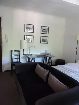 a living room with a couch and a table at Appartement Cours Mirabeau CrsMb in Aix-en-Provence