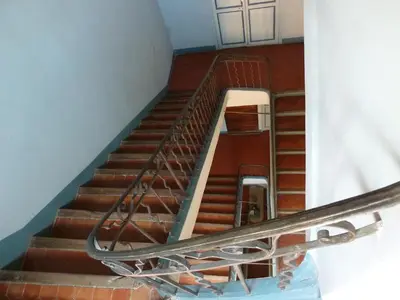 an empty staircase in a building with a metal railing at Appartement Cours Mirabeau CrsMb in Aix-en-Provence