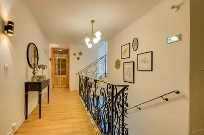 a staircase in a home with a wrought iron railing at Logis Hotel Le Blason de Provence in Monteux