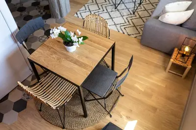 a dining room table with chairs and flowers on it at DUPLEX MIRABEAU - Roof terrace with panoramic view in Aix-en-Provence