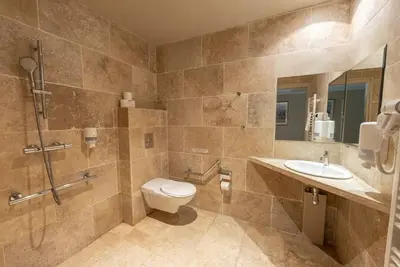 a bathroom with a toilet and a sink at Vacances Bleues Hôtel Castel Luberon in Apt