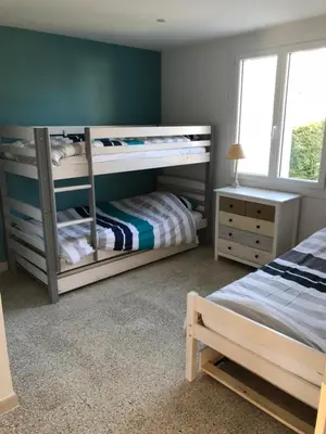 a bedroom with two bunk beds and a desk at Villa Camille in Céreste
