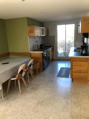 a kitchen with a table and chairs in a room at Villa Camille in Céreste