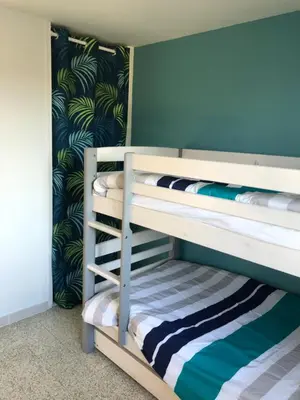 a bedroom with two bunk beds with blue walls at Villa Camille in Céreste