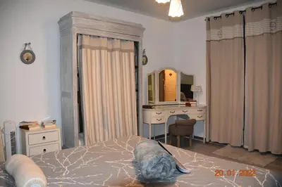a bedroom with a bed and a desk and a mirror at Villa Lumières in Goult